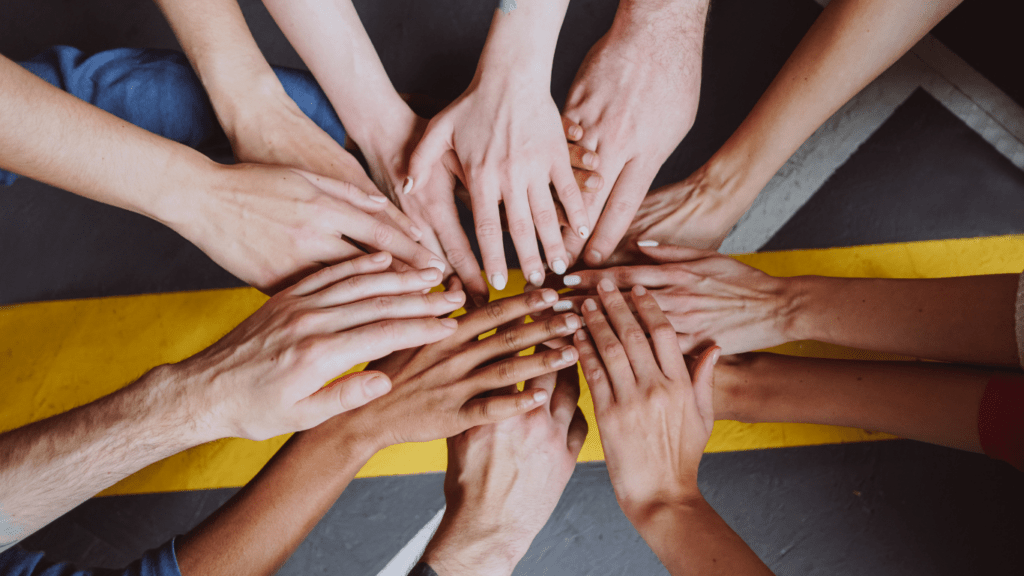 a group of people making a high five with their hands