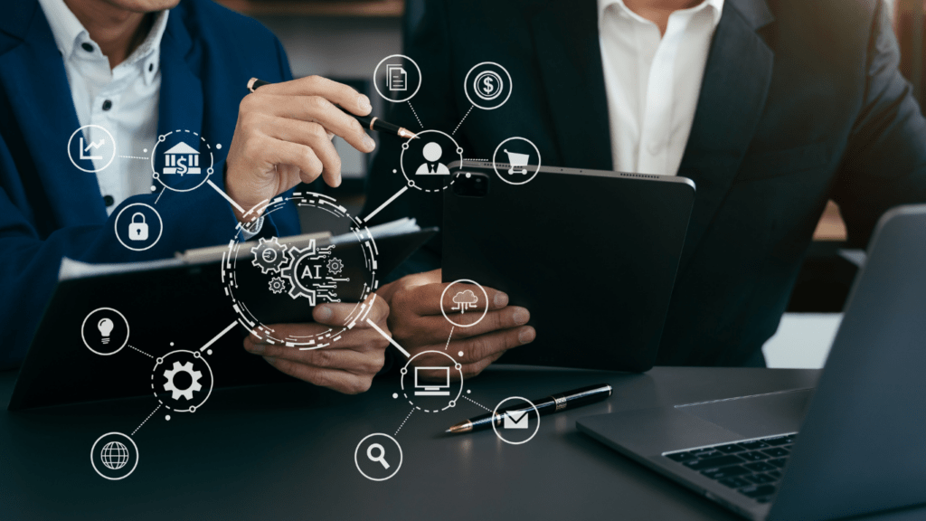 business people sitting at a table with a laptop and a tablet