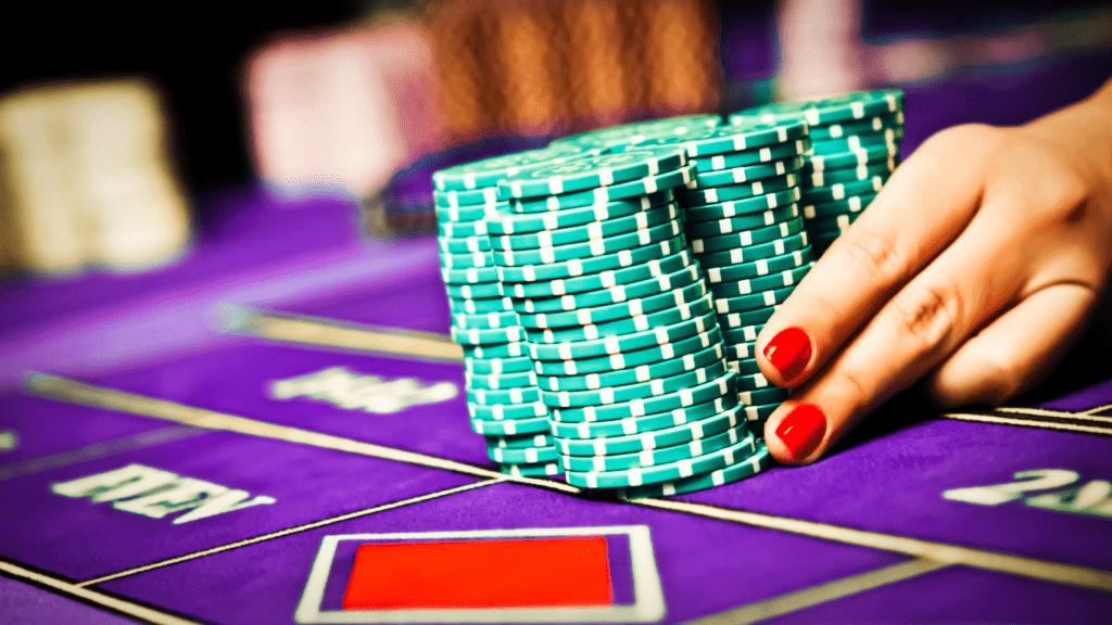 a person holding a casino chips