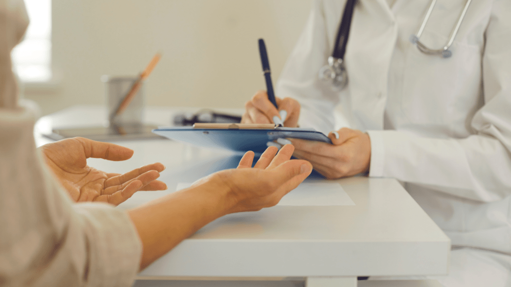 a doctor talking to a patient at a desk