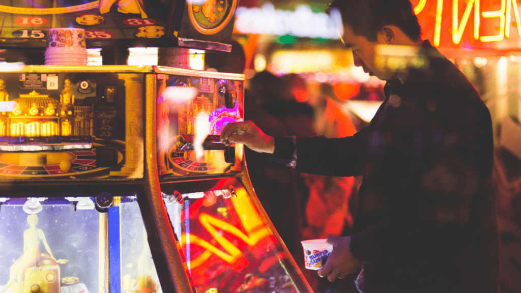 a person playing a slot machine at night