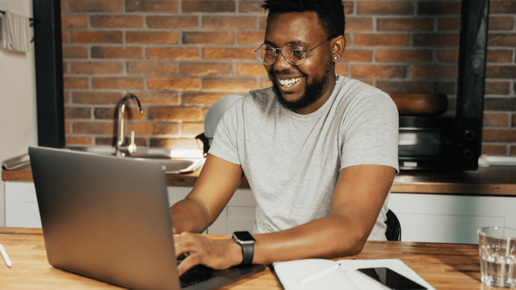 a person sitting at a desk with a laptop