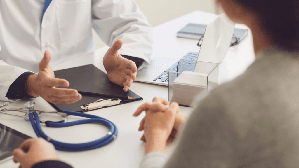 a doctor talking to a patient at a desk