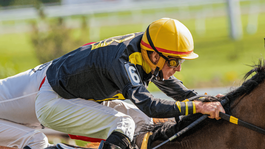 a jockey on a horse racing down the track