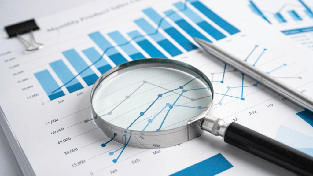 a magnifying glass and a pen on top of a business report