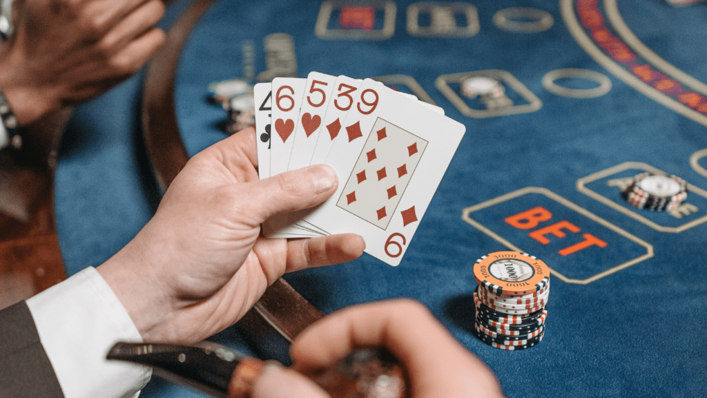 a person holding a casino playing cards