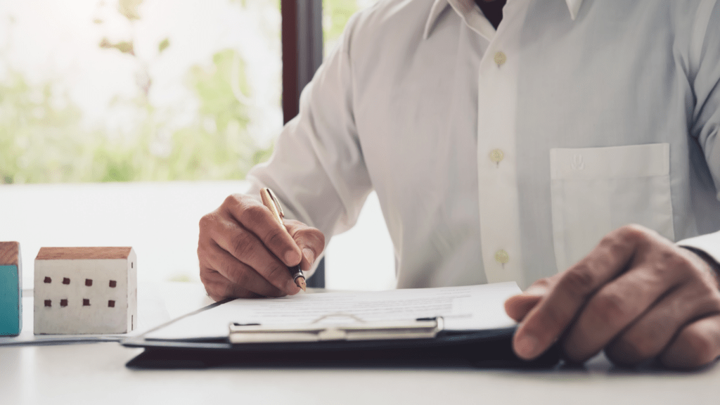 a person in a suit writing on a piece of paper