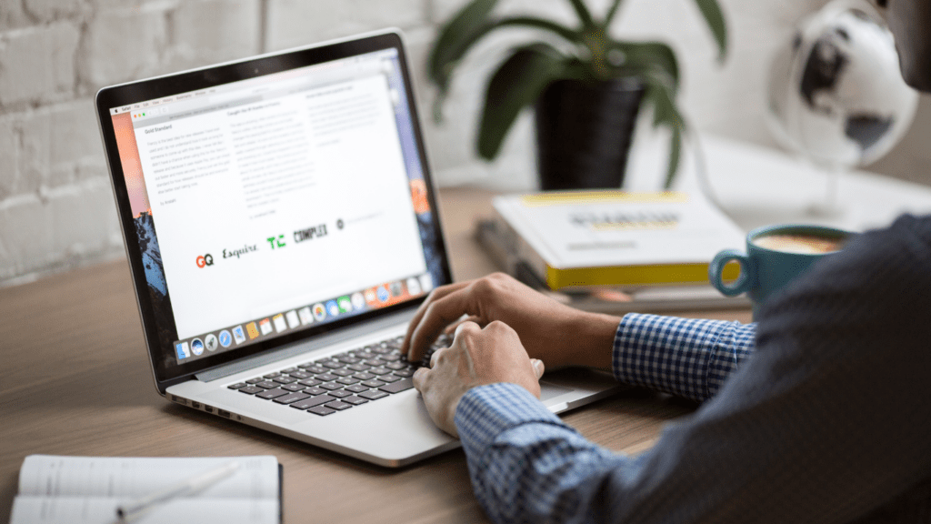 a person sitting at a desk with a laptop