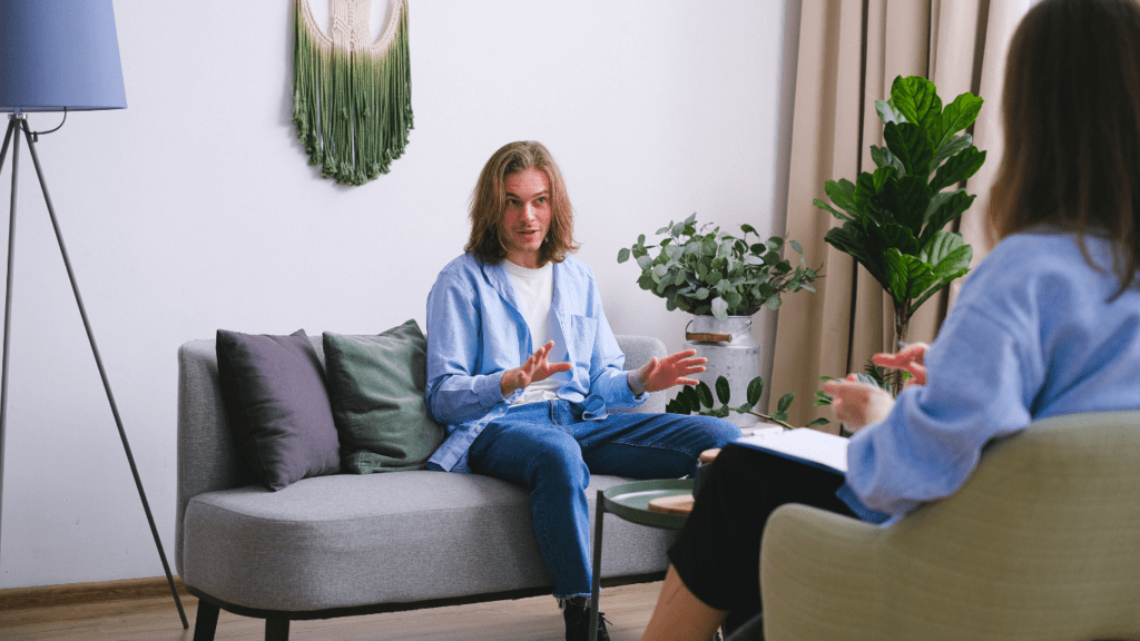 two people talking to each other in a living room